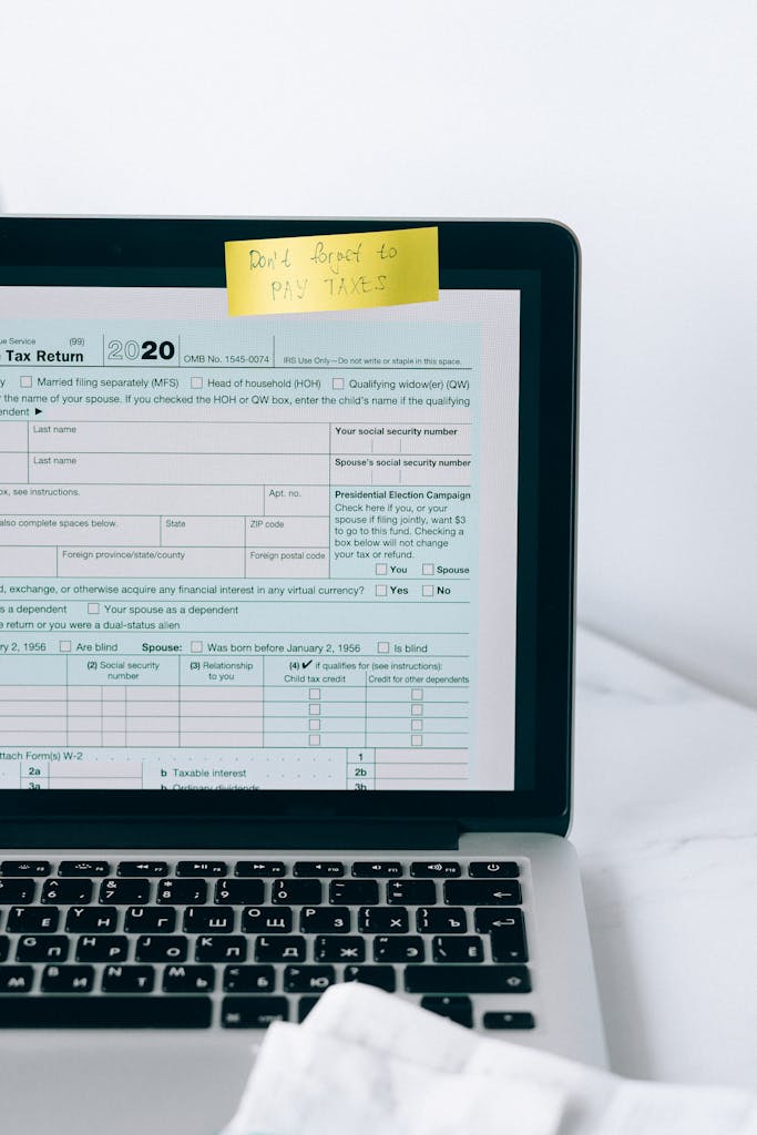 Laptop showing tax form with a reminder note, emphasizing tax payment.